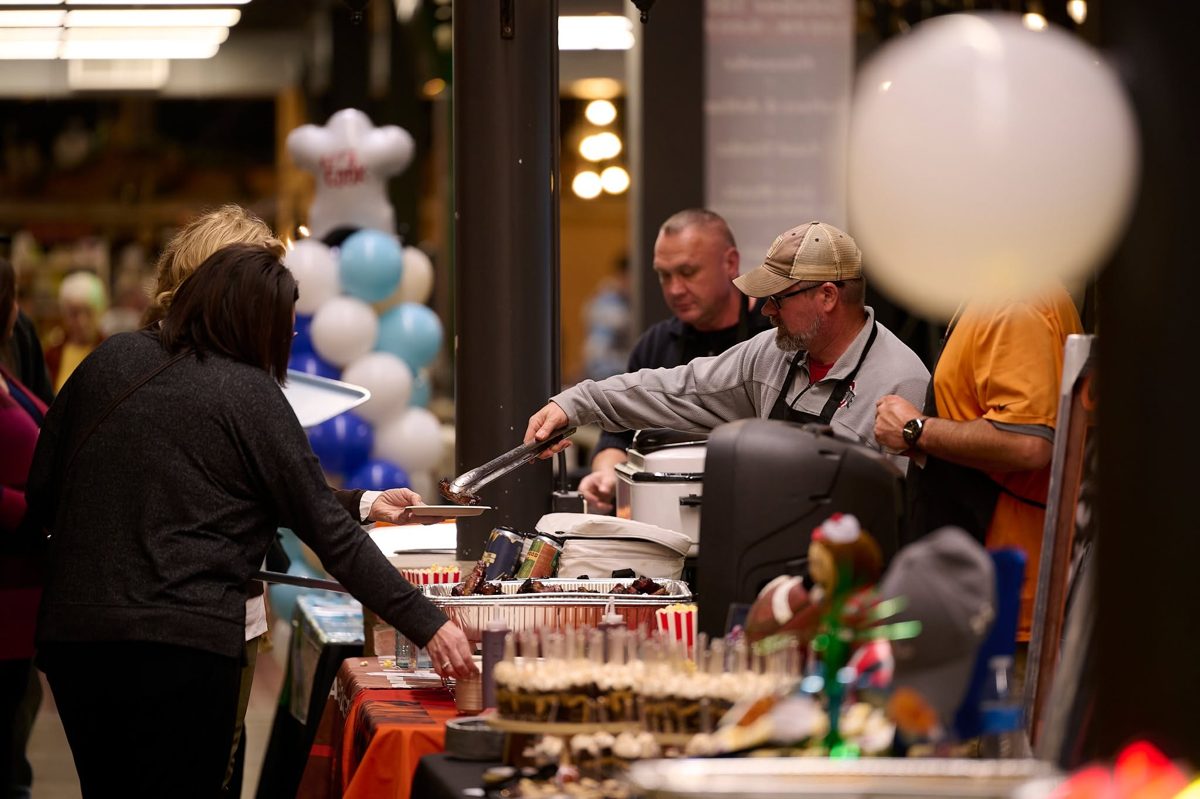 Guests enjoying food and prizes at a Love Our Community event